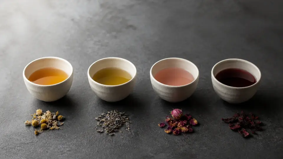 Four unbranded cups illustrating cycle phase tea rituals Four unbranded cups illustrating cycle phase tea rituals