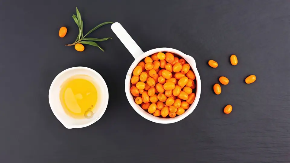 High-Quality Macro Image of Sea Buckthorn Berries and Golden Oil High-Quality Macro Image of Sea Buckthorn Berries and Golden Oil
